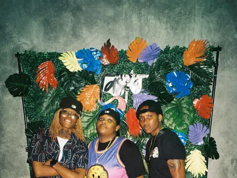 Guests in front of a floral photo backdrop at a themed night at The Catwalk Club (Sat 11 June)