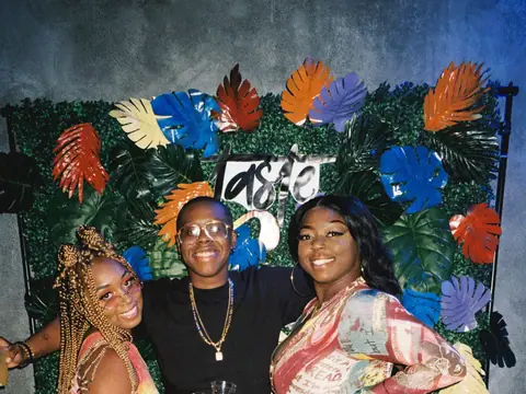 Guests in front of a floral photo backdrop at a themed night at The Catwalk Club (Sat 11 June)