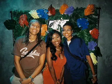 Guests in front of a floral photo backdrop at a themed night at The Catwalk Club (Sat 11 June)